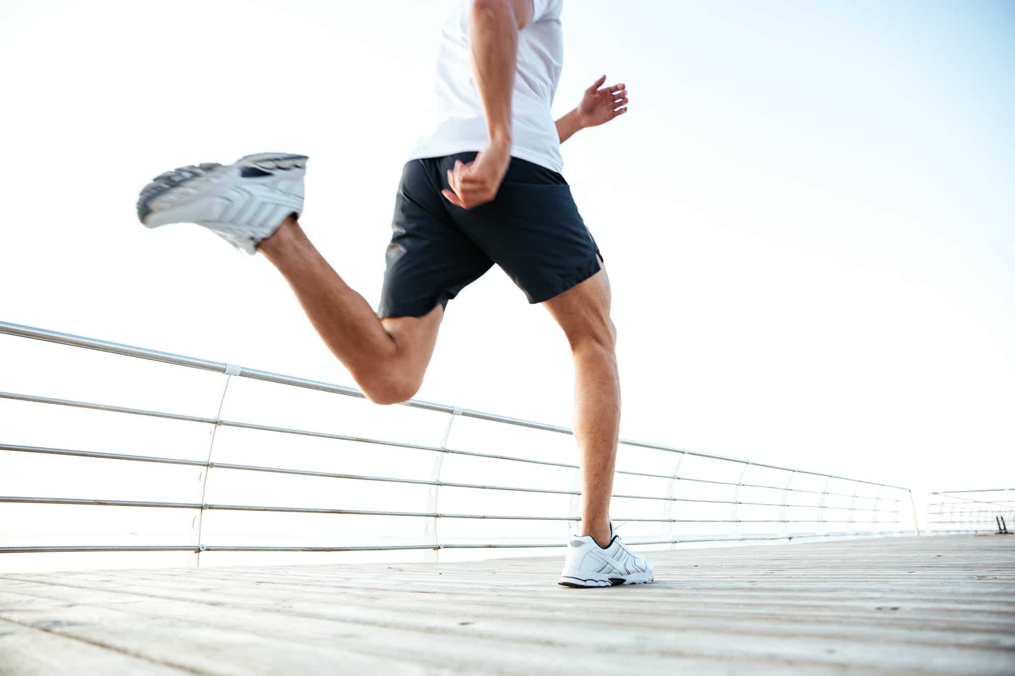 Cropped image of athlete runner's feet and shoes running