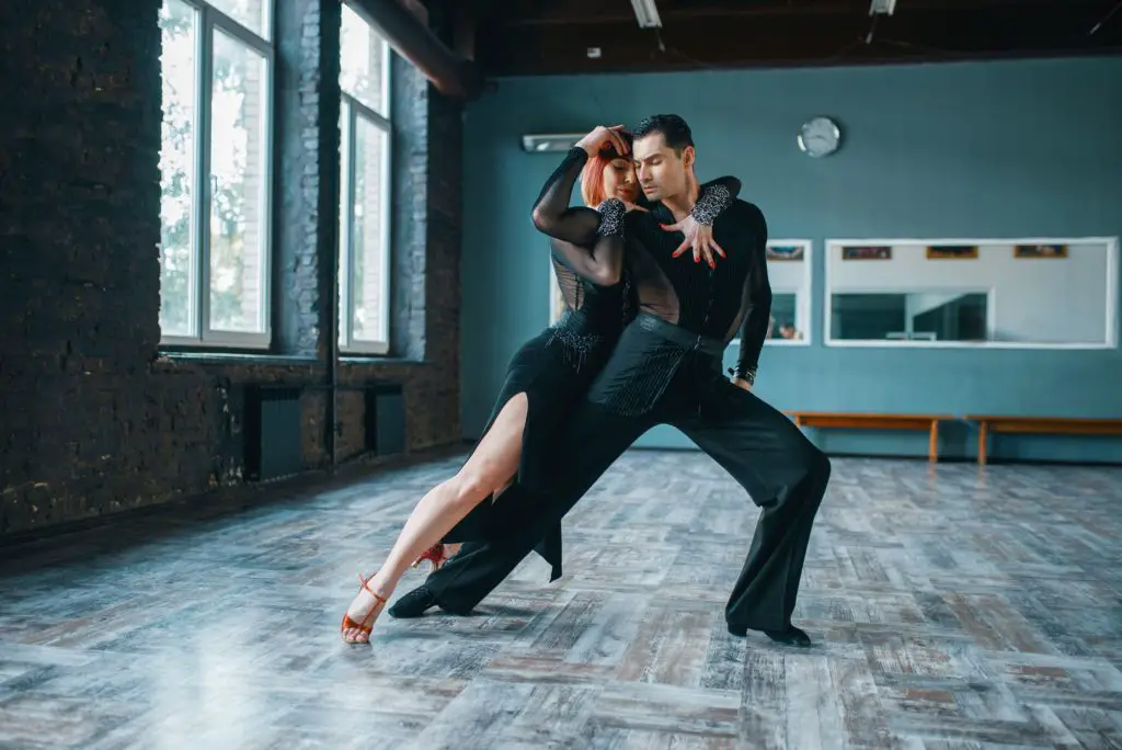 Two dancers in costumes on ballrom dance training