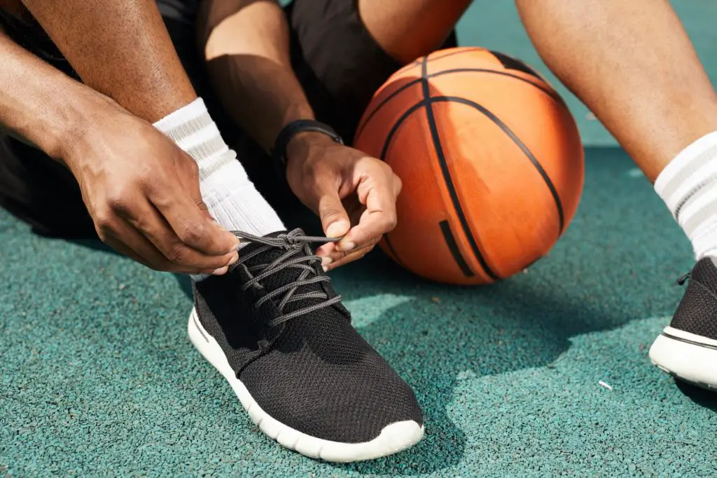 African Sportsman Tying Shoes