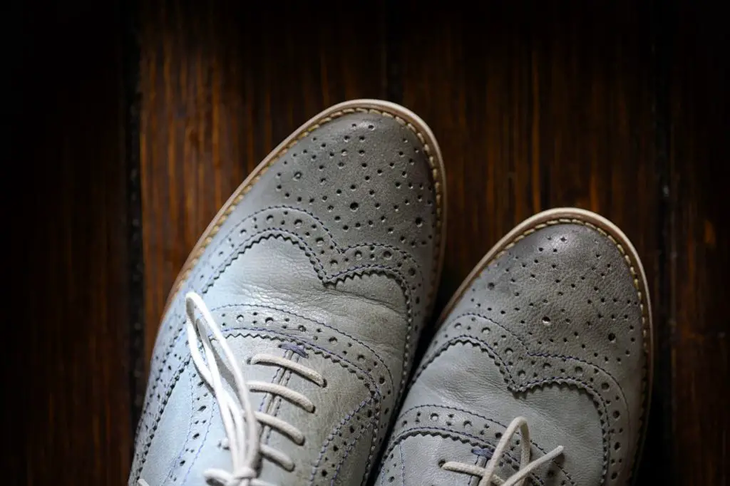 Grey oxford shoes on wooden background