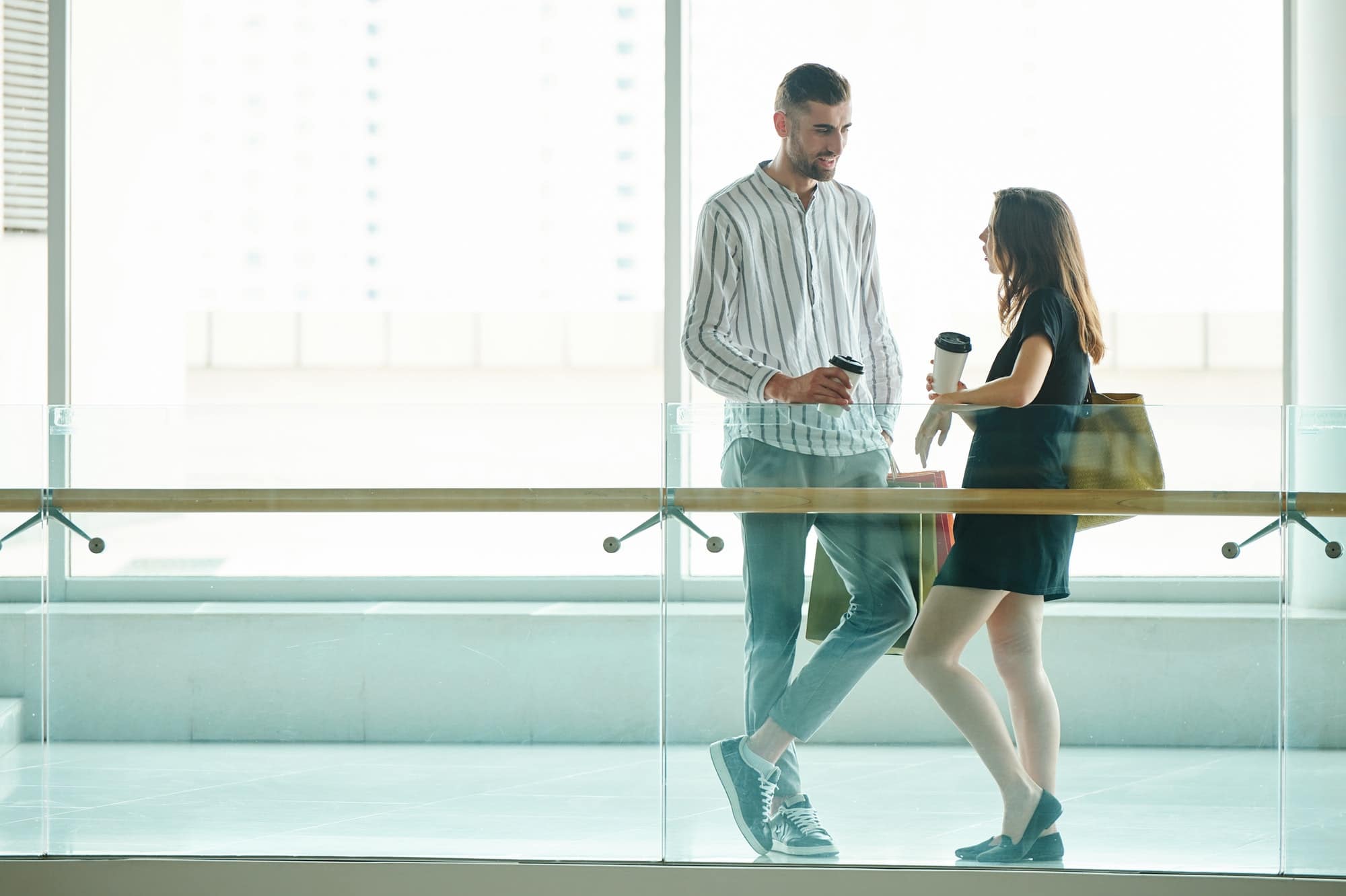 Tall young man talking to girlfriend