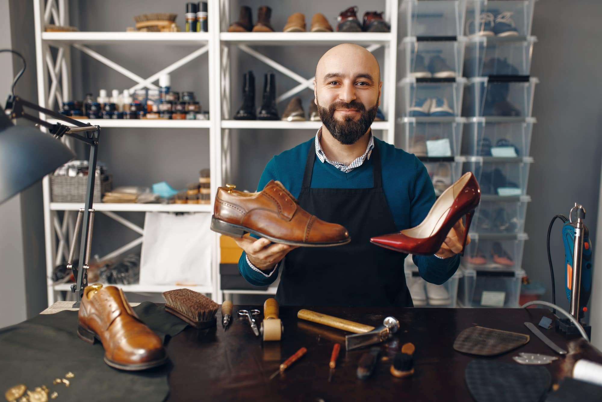 Bootmaker shows repaired shoes, footwear repair