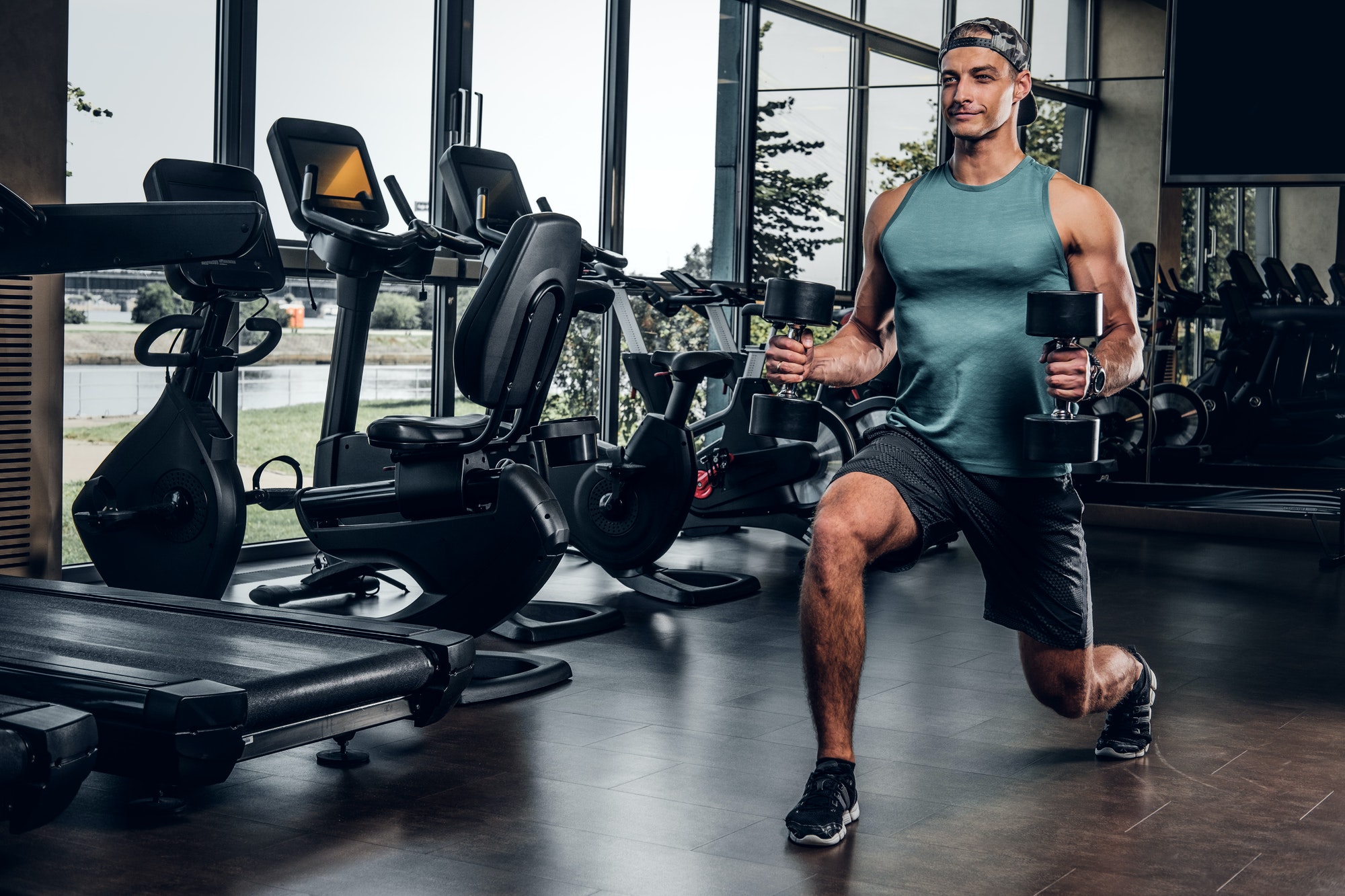 Man has training with dumbbells at gym