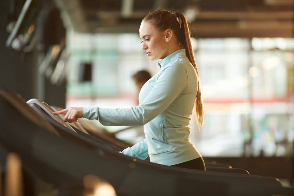 Young Woman on Treadmill Side View