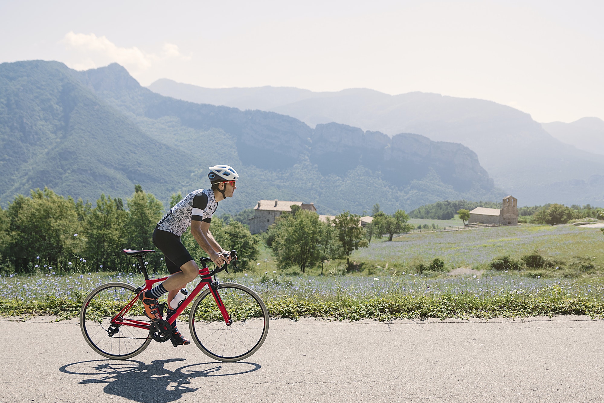 Men cycling mountain road at morning