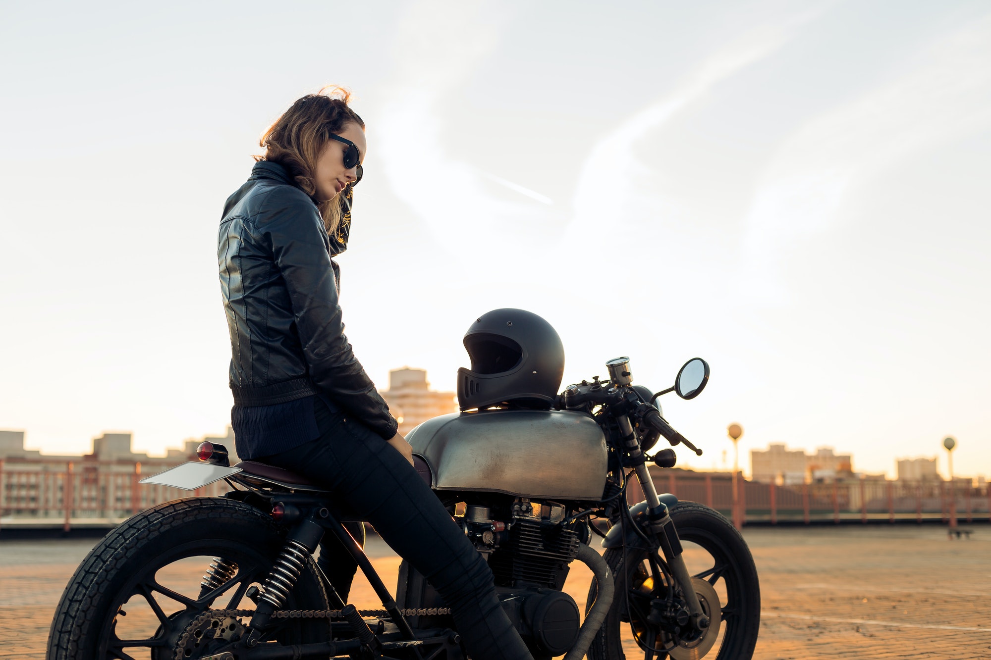 Biker girl on caferacer motorcycle.