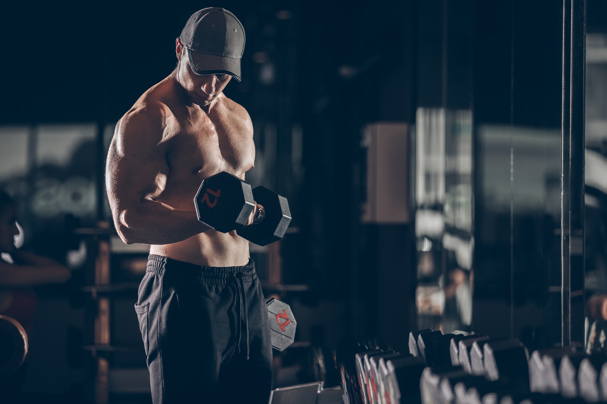 building muscle by lifting dumbbells