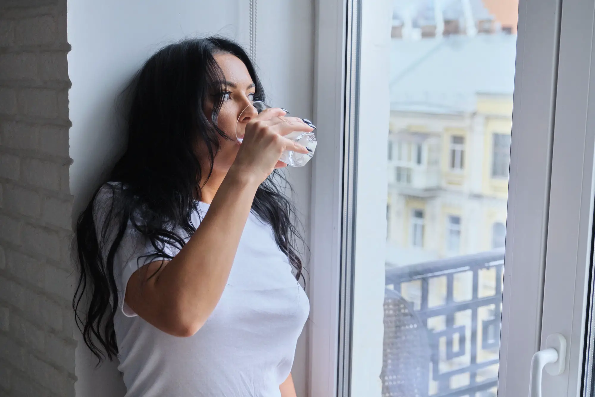 Beautiful woman drinking milk drink, yougurt from glass
