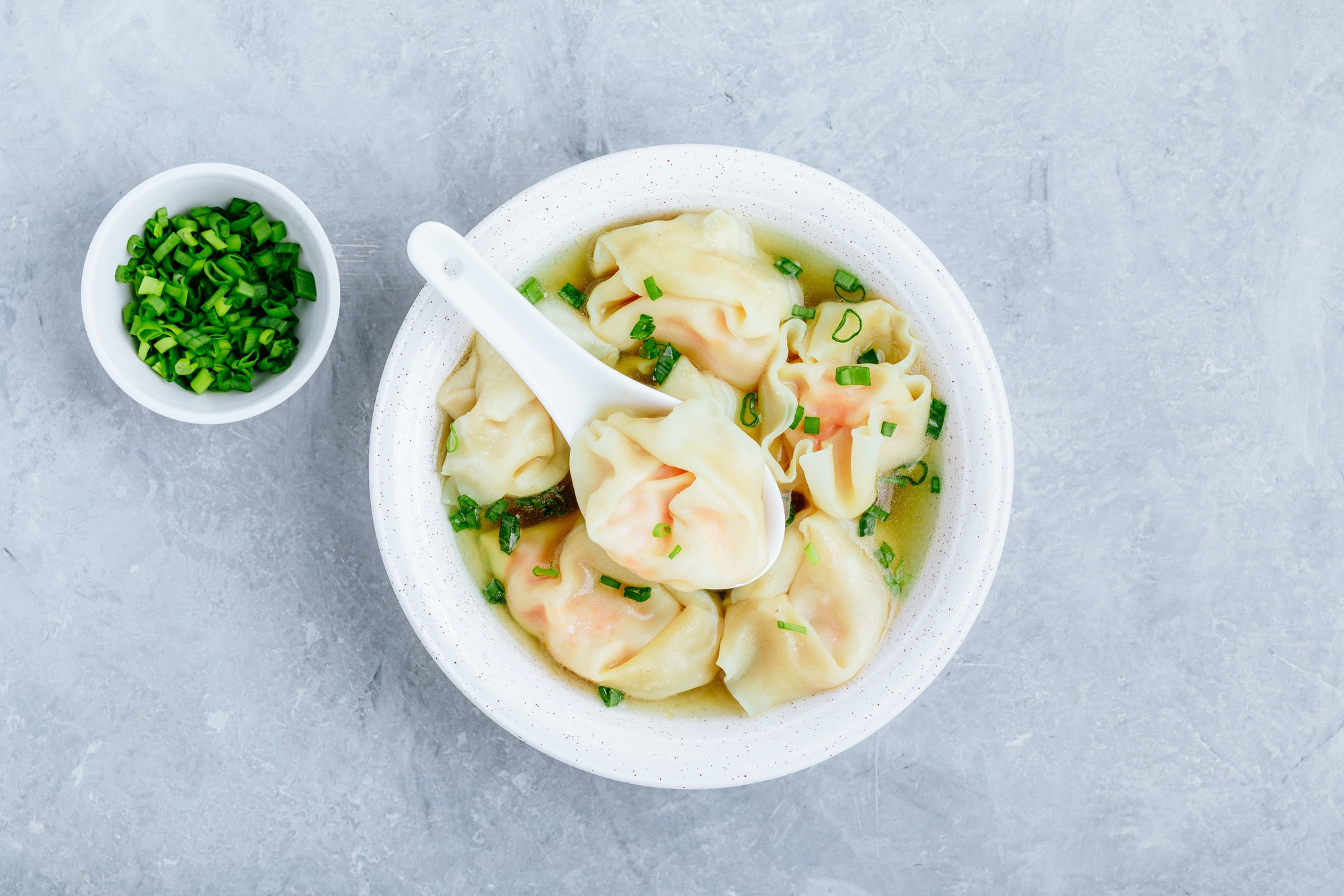 Wonton soup bowl. Shrimp or pork wonton soup with green onion