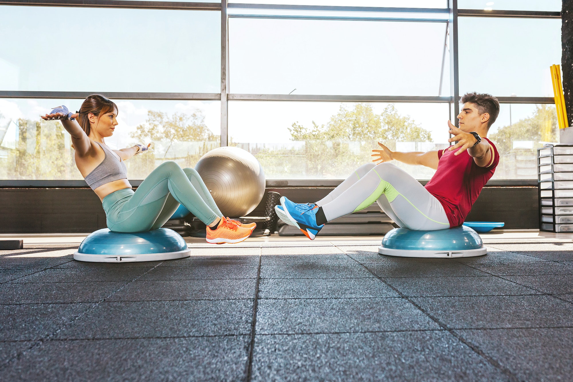 Couple doing exercises on the bosu abdominal muscles