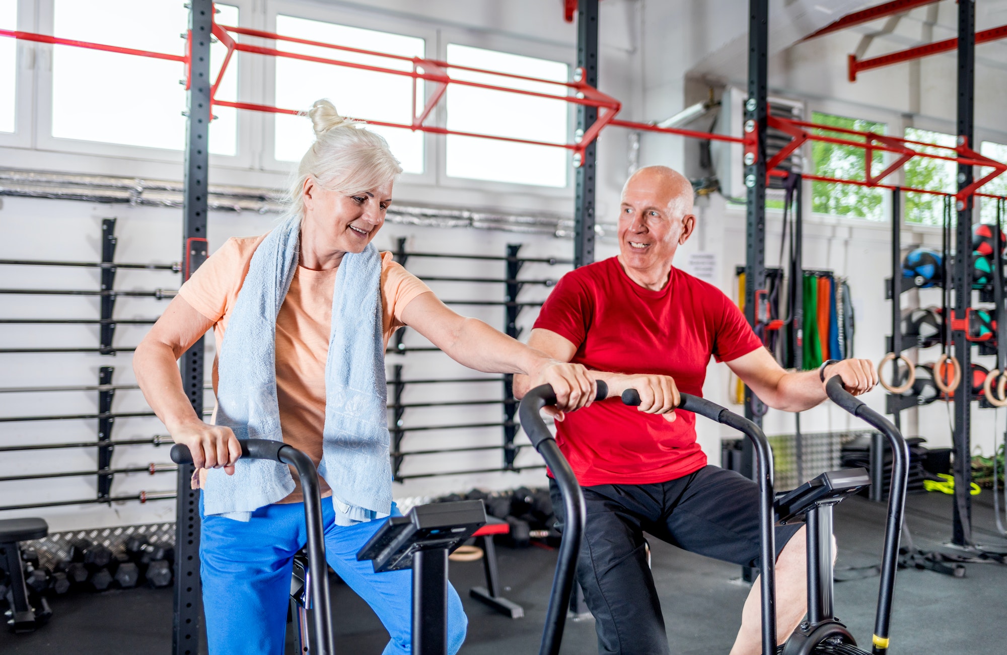 Senior couple biking at the gym